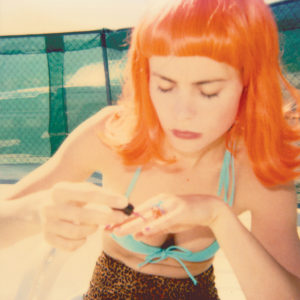 Radha-doing-her-Nails-by-the-Pool-(29-Palms,-CA)-Stefanie-Schneider-saatchi-art-orange-hair-bikini-photography