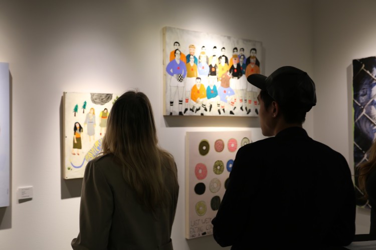Visitors admire works by Kelly Puissegur
