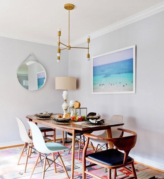 dean west's tranquil beach photography hangs in this dining room
