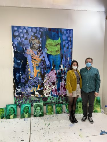 Fair Director Nicole Garton with artist Bartosz Beda in front of a blue painting, measuring 6 by 8 feet tall.