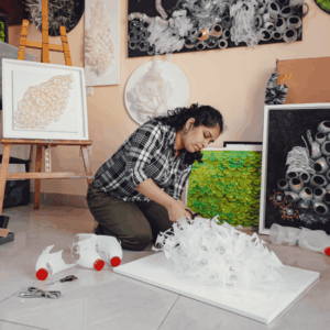 Artist Swapna Namboodiri working on a reclaimed plastic sculpture inspired by nature.