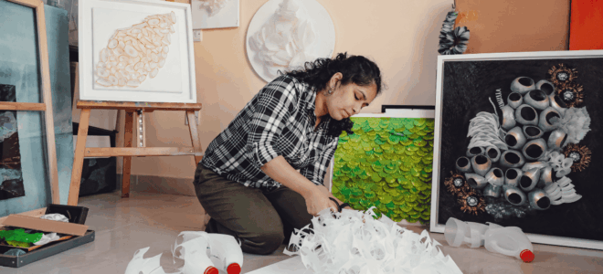Artist Swapna Namboodiri working on a reclaimed plastic sculpture inspired by nature.