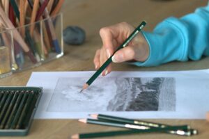 Artist Vera Hoi works on a landscape drawing. 