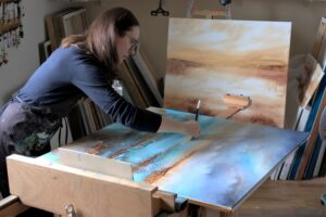 Artist Vera Hoi works on a painting in her studio.